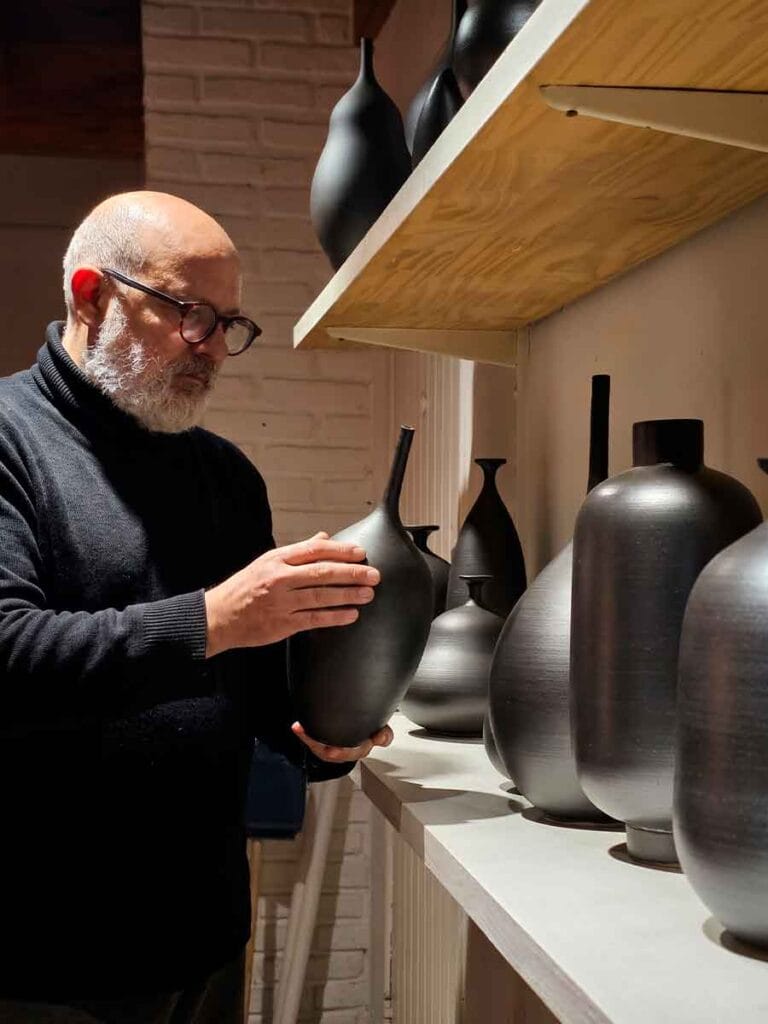 Fernando Durao ceramic artist selecting finished pieces — Buenos Aires studio, 35 years of practice