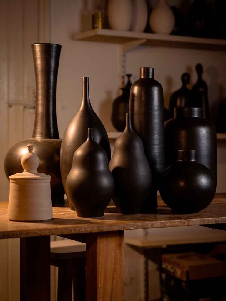 Studio pottery shelves with pieces in different stages — Fernando Durao's Buenos Aires workshop