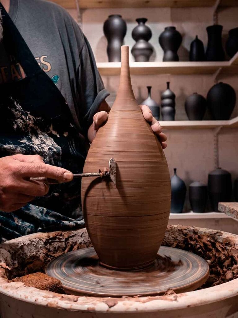 Trimming a leather-hard stoneware piece on the wheel — Fernando Durao's studio process, Buenos Aires
